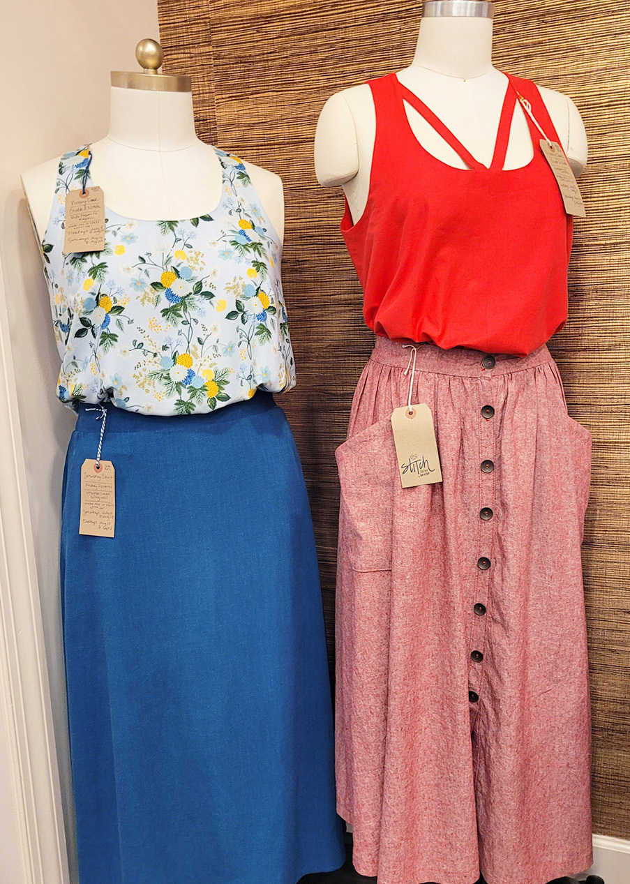 the victory tank in two views displayed on dress forms with two different maxi skirts.